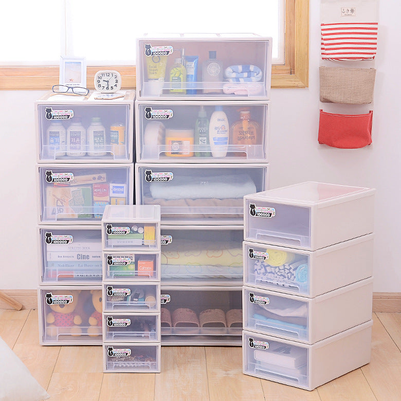 Plastic storage drawers are neatly arranged, filled with various items like toiletries, books, towels, and shoes. Some small hanging pockets on the wall hold additional items.