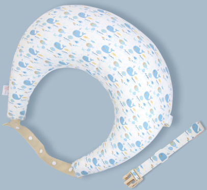 U-shaped white nursing pillow with blue and yellow whale patterns, featuring a beige strap and a matching adjustable belt with a buckle, set against a light blue background.