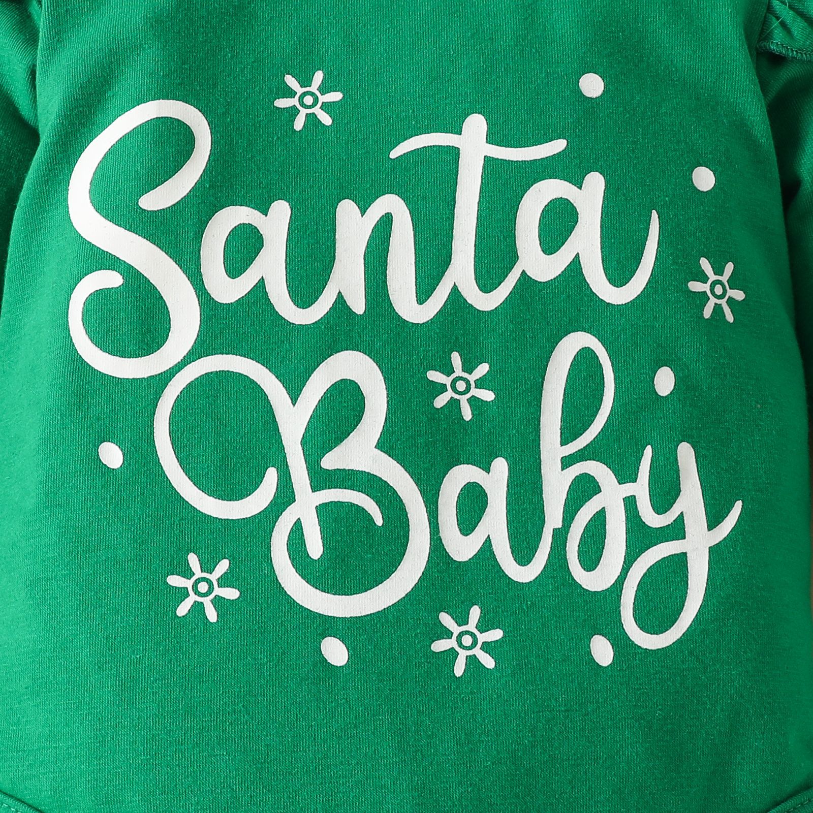 Green fabric with white text reading "Santa Baby," decorated with small snowflake and dot designs.