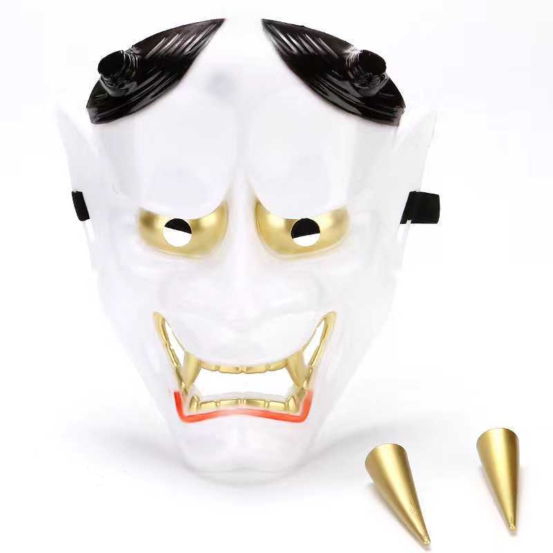 White demon mask with gold eyes and fangs, featuring black horns and two additional gold horn attachments on the side. The mask has a menacing expression.