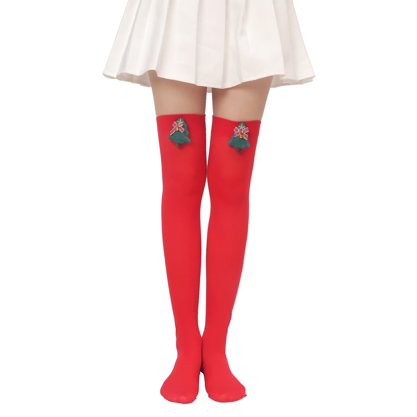 Woman wearing a white skirt and bright red thigh-high socks with Christmas tree decorations near the top. The background is plain white.