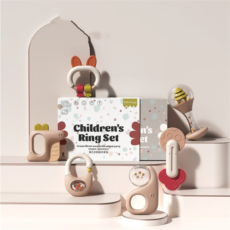 Children's Ring Set packaging with various colorful and whimsical ring toys displayed around it. The toys are designed in soft pastel colors and imaginative shapes.