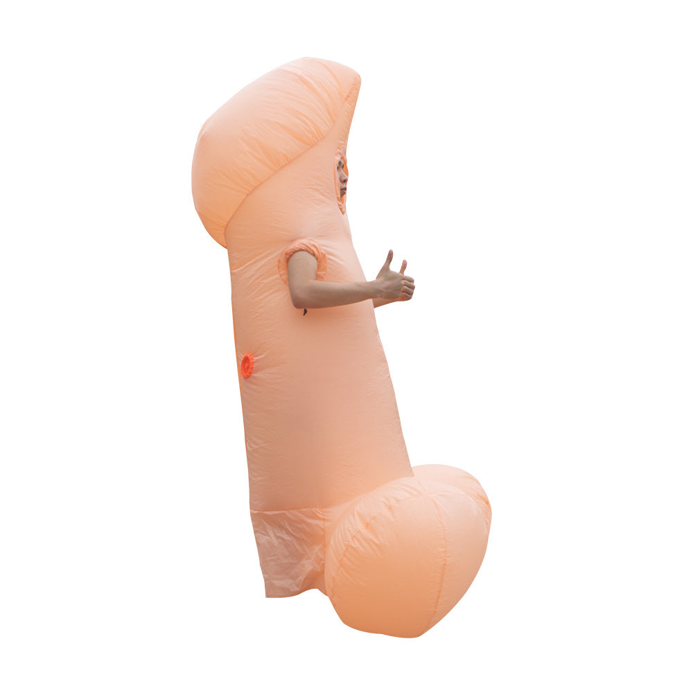 An individual in an inflatable costume shaped like a humorous phallic symbol is posing with their arm outstretched, giving a thumbs-up. The costume is large and covers the person's entire body, with their face barely visible, creating a comedic effect.