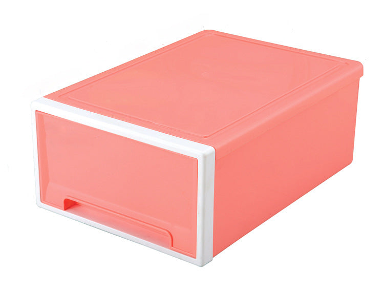 Coral pink plastic storage box with a white-rimmed front and handle. The rectangular design is stackable, making it ideal for organizing and maximizing space.