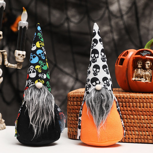 Two Halloween gnomes with long beards and tall hats adorned with skull patterns stand on a surface. One gnome wears a multicolored hat, while the other has a black and white design. In the background, a skeleton candlestick and a pumpkin with skeleton figures are visible against a dark, web-like backdrop.