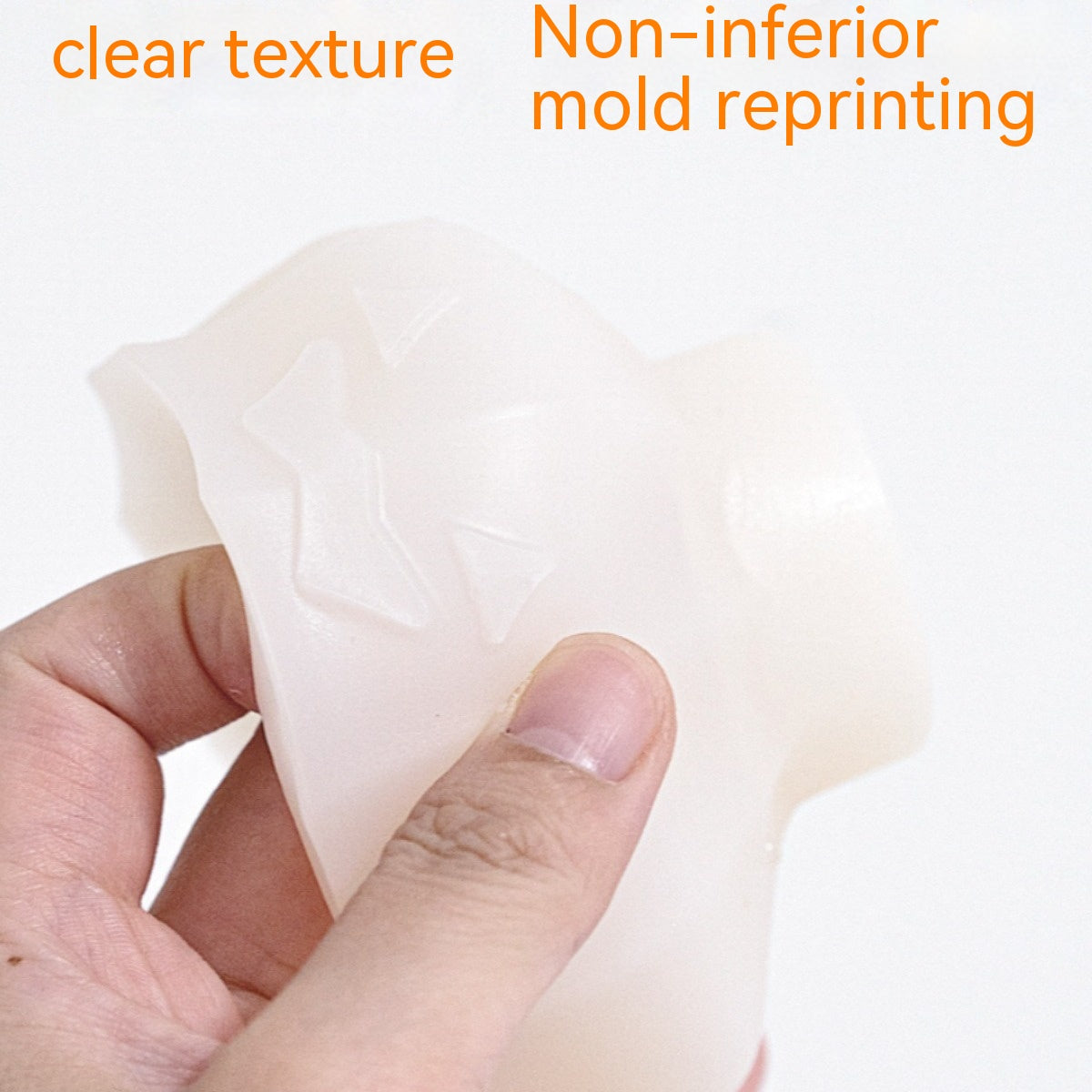 Hand holding a translucent silicone mold with embossed shapes, featuring text "clear texture" and "non-inferior mold reprinting" in orange above.