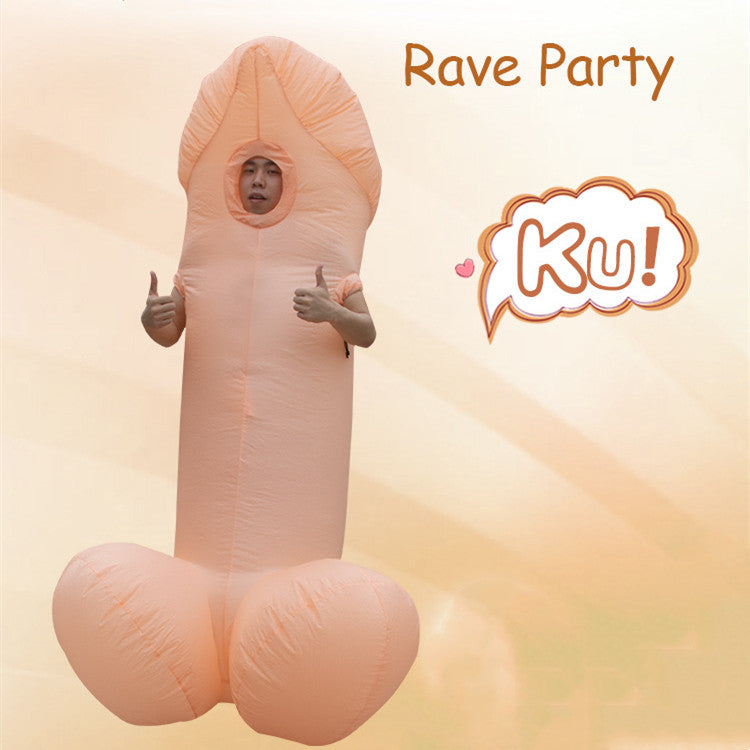 A person wearing an inflatable costume shaped like a large, cartoonish phallic symbol, giving a thumbs-up gesture. The costume is light pink and covers their entire body with a face opening. The words "Rave Party" and "Ku!" are written in playful text on a light background.
