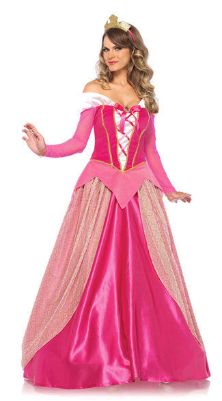 A woman in a bright pink princess costume poses confidently. The dress features a flowing skirt, patterned overlays, long sleeves, and a crown, embodying a fairytale theme.