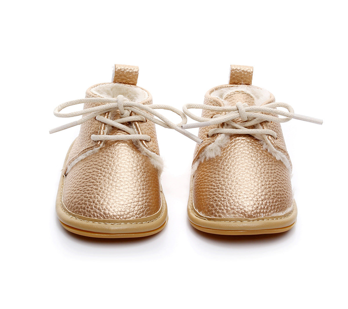 Gold metallic baby shoes with white laces and cozy fur lining, viewed from the front. Textured leather finish and pull tabs on the heels, suitable for infants.