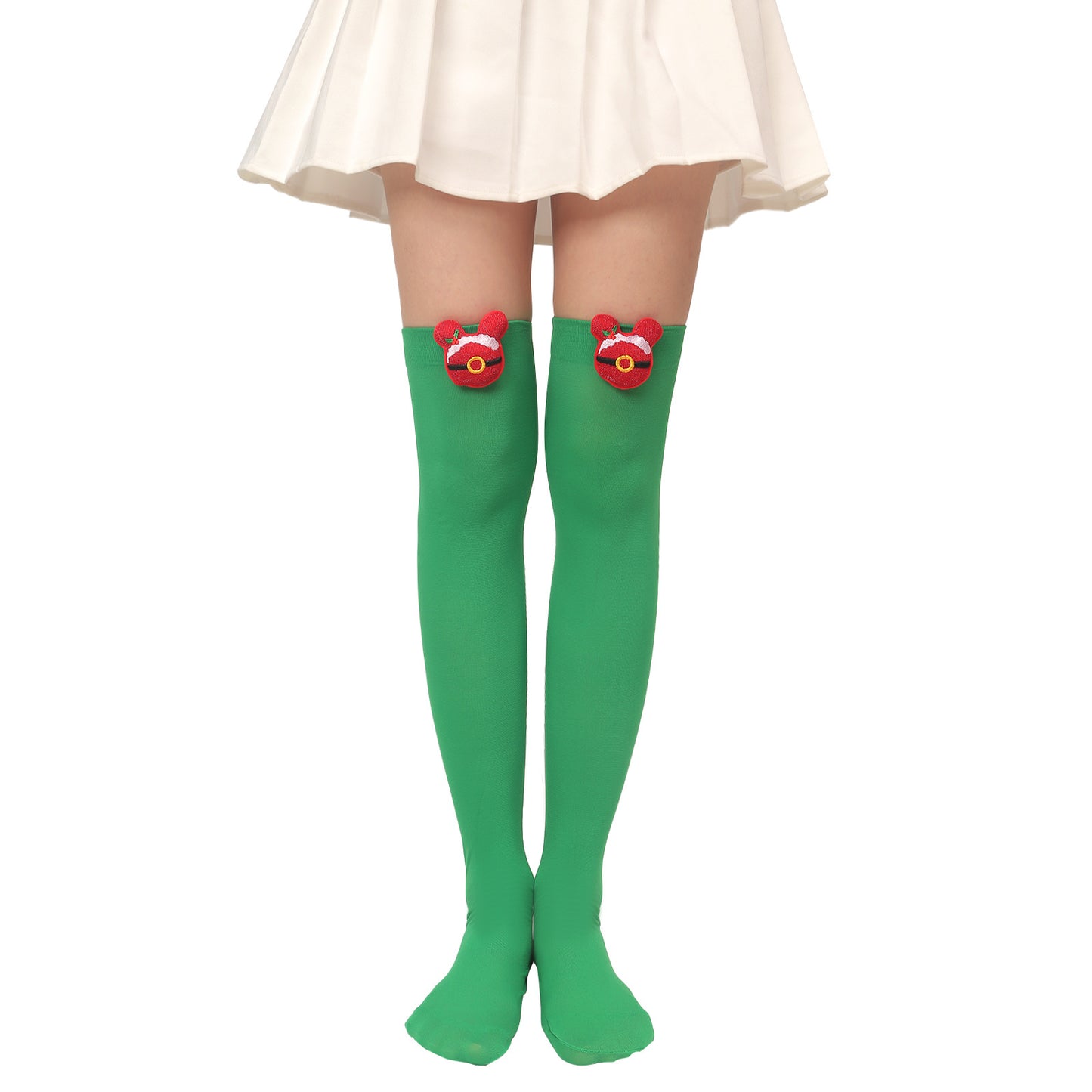 Person wearing green thigh-high socks adorned with festive red bear designs below a white skirt.