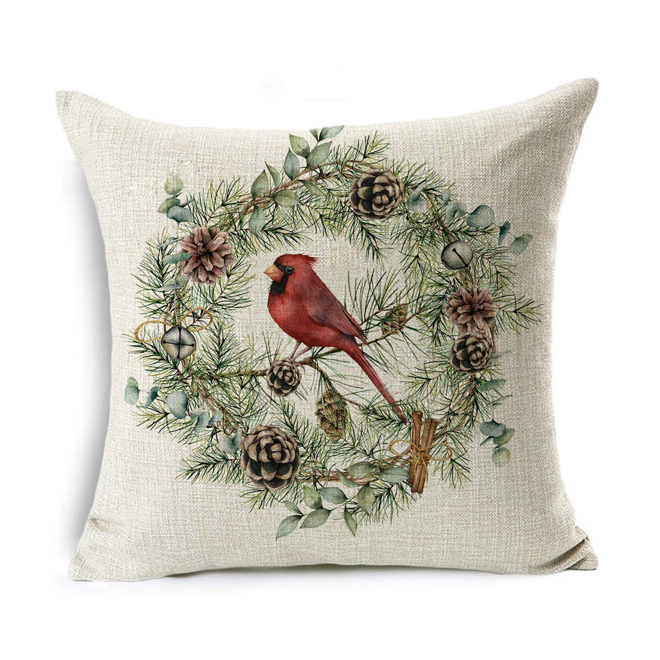 A decorative pillow featuring a red cardinal perched on a wreath of pine branches, cones, and leaves, set against a light beige fabric background.