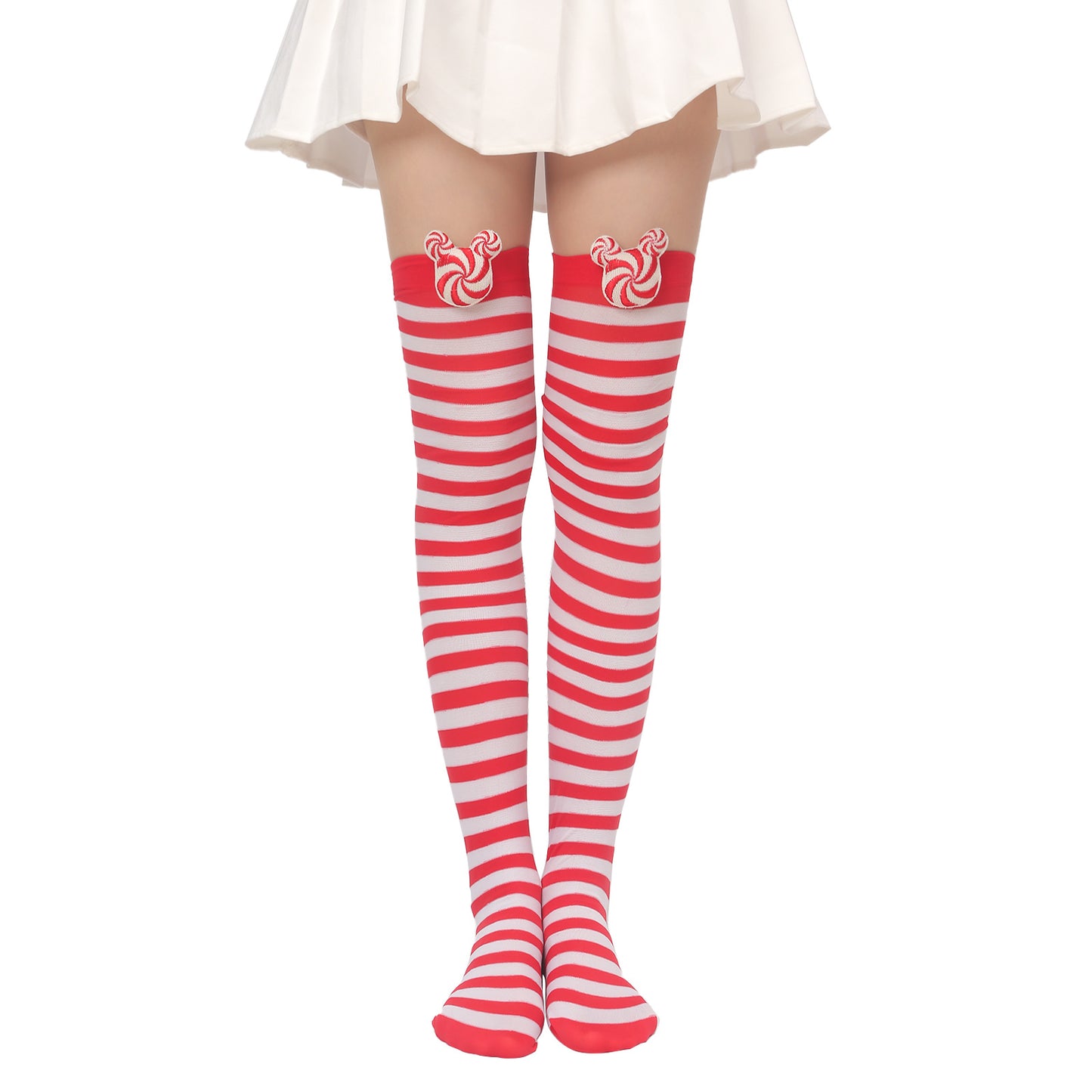 Woman in a white skirt wearing knee-high red and white striped socks with peppermint candy designs near the top, standing on a white background.