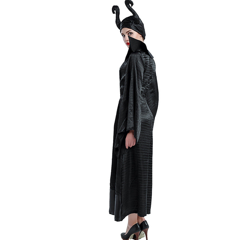 Person in a black, textured robe with a high collar and twisting horned headdress, resembling a villainous character, stands in profile, wearing black high heels.