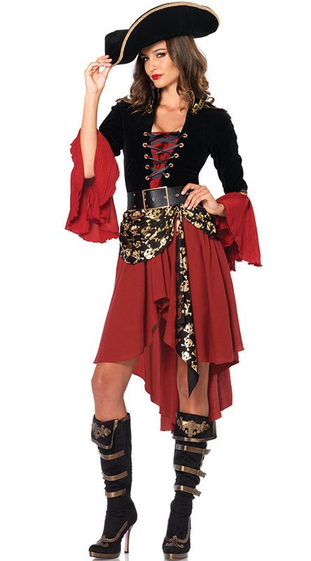 Woman in a pirate costume with a black hat, black corset with gold lacing over a red dress with flared sleeves, a skull-patterned sash, and tall black boots with gold accents.