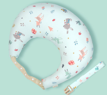 Curved baby pillow with colorful animal and tree patterns on a light blue background. Includes a removable strap with a buckle.