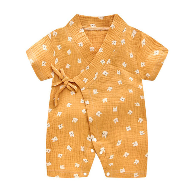 Orange baby romper with white animal patterns, featuring short sleeves, a wrap-style front with a side tie, and front buttons for easy fastening. Made from soft, textured fabric.