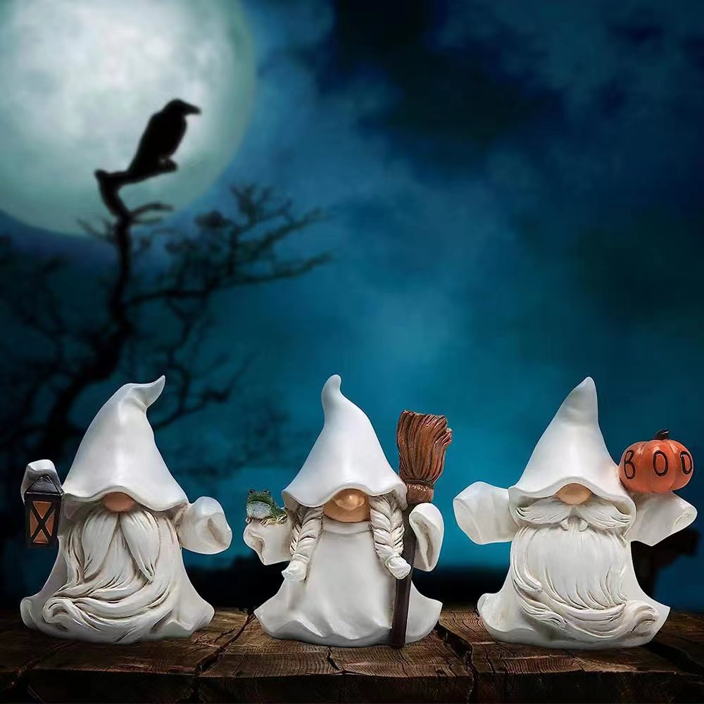 Three gnomes in white robes, one holding a lantern, another with a broom and frog, and the third with a pumpkin, under a full moon with a silhouetted crow on a branch.