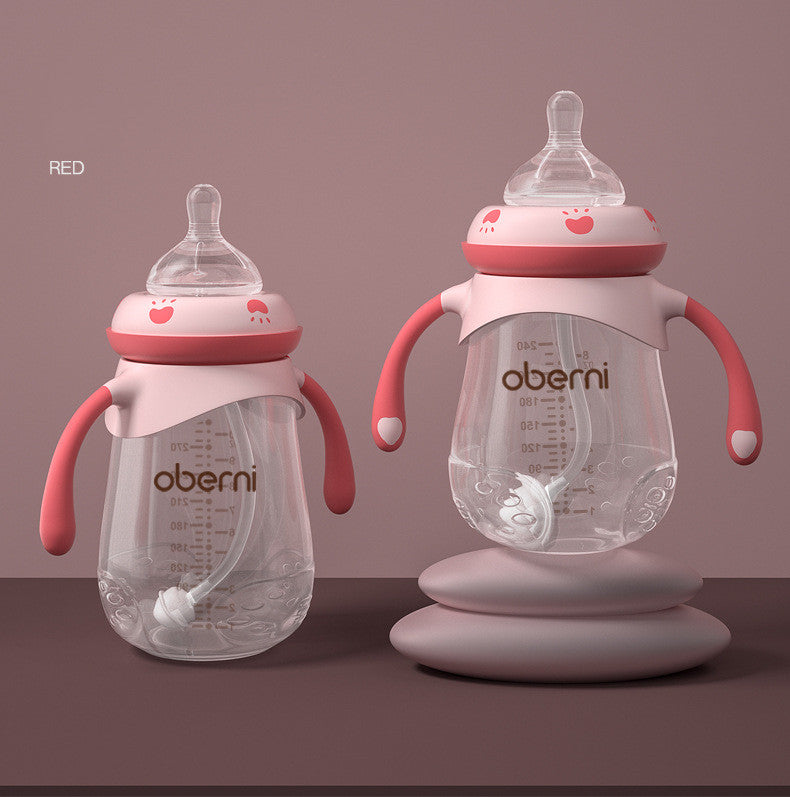 Two clear baby bottles with pink handles and lids are set against a mauve background. They feature measurement markings and the brand name 'Oberni' on the front.