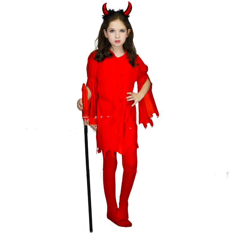 Young girl in a red devil costume with horns, holding a black pitchfork. She stands confidently with one hand on her hip against a white background.
