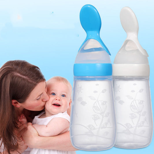 A mother kisses her smiling baby against a blue background. Two large baby bottles with lids resembling spoons, one blue and one white, are prominently displayed beside them.