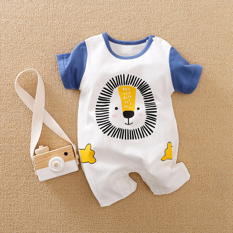 Baby romper with a cute lion face design, featuring blue sleeves and playful yellow accents, laid next to a wooden toy camera on a textured beige background.