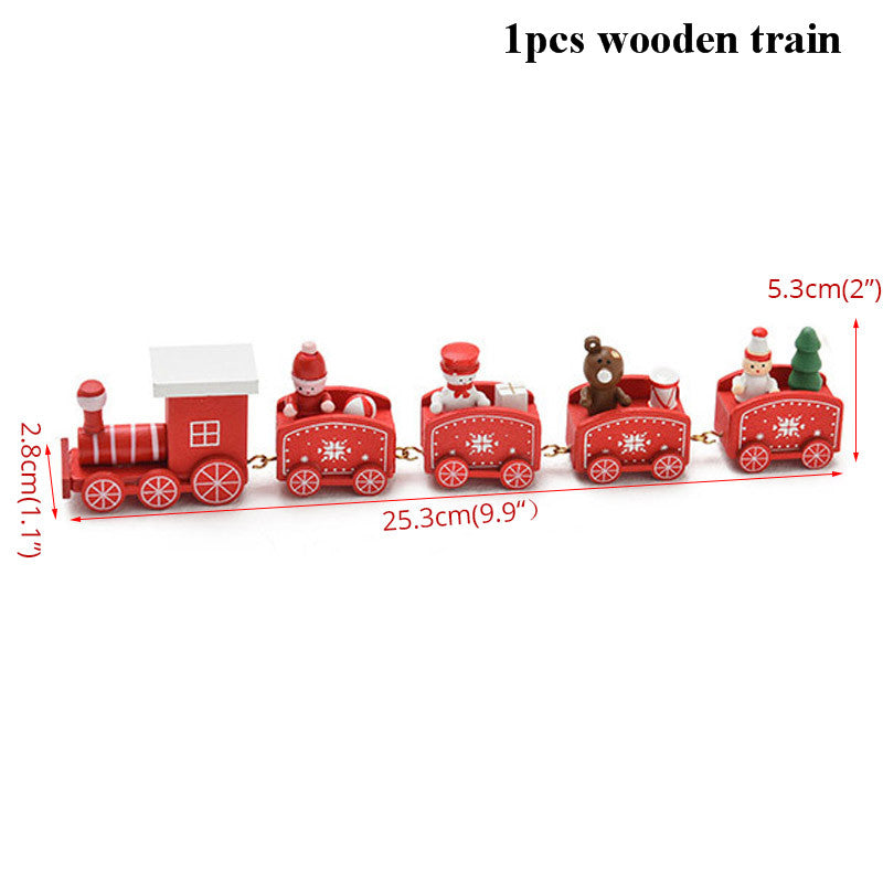 Red wooden toy train with five cars featuring festive designs, including Santa and a Christmas tree. The train measures 25.3 cm long, with individual carriages 5.3 cm tall.