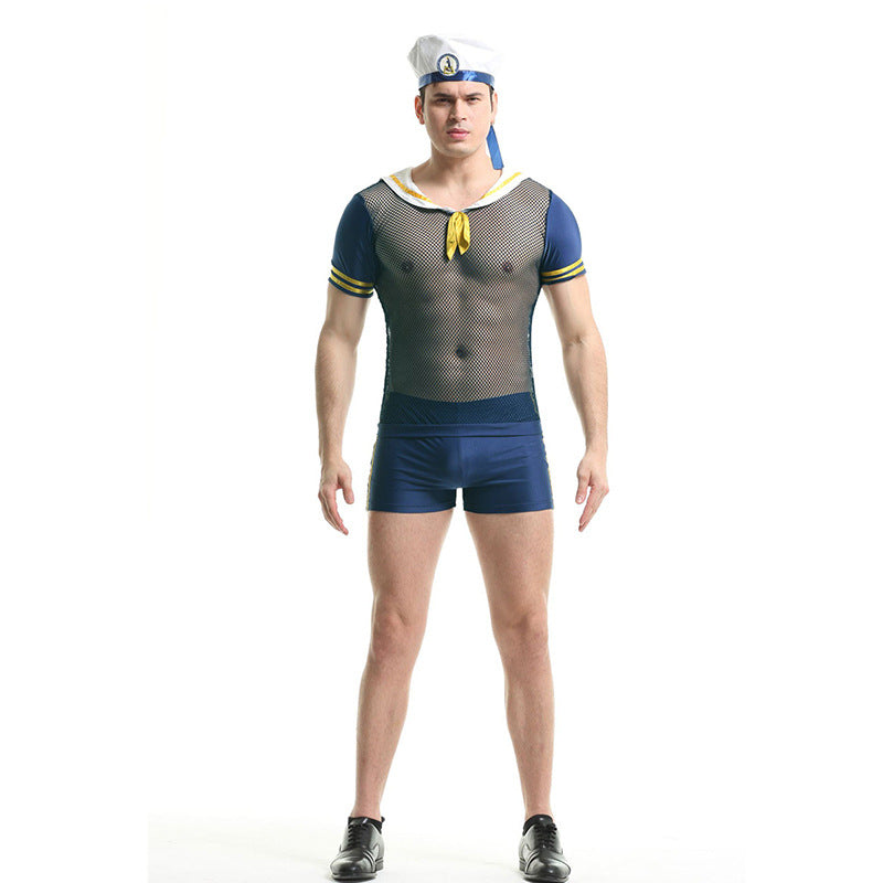 Man wearing a sailor costume with a mesh top, navy shorts, and a sailor hat, stands facing forward against a white background.