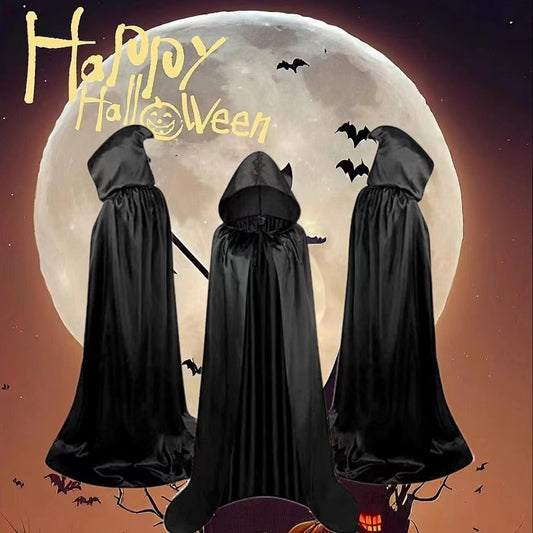 Three hooded figures in black cloaks stand before a large full moon, surrounded by flying bats. "Happy Halloween" is written in whimsical yellow text above them.