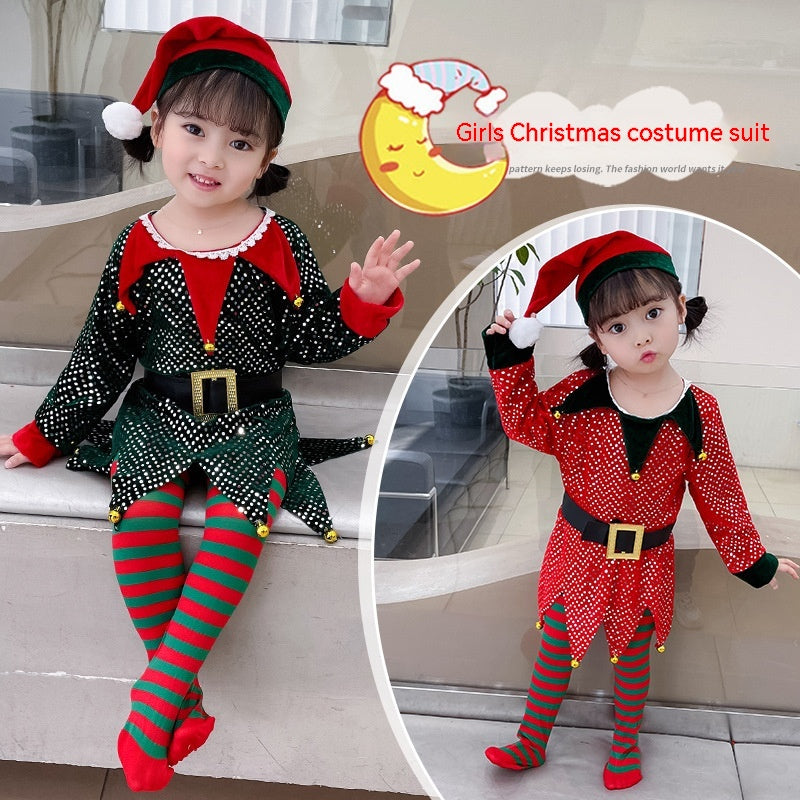 A young child in an elf costume with red and green striped tights, wearing a red Santa hat. The outfit features a black and red tunic with a belt and gold accents.