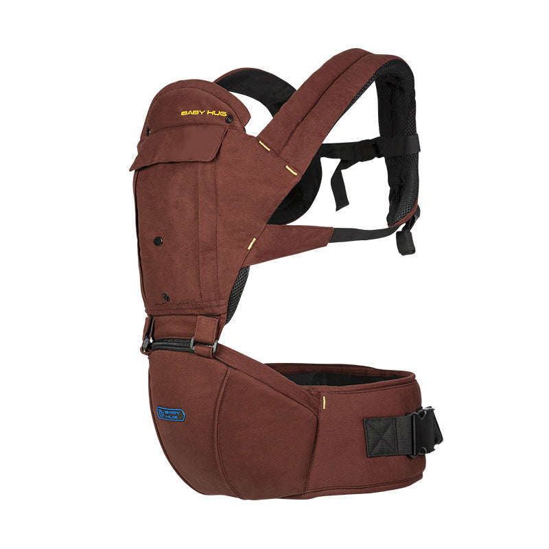Brown baby carrier with padded shoulder straps and a secure waist belt, designed for comfort and support. Features pockets and adjustable fastenings for a snug fit.