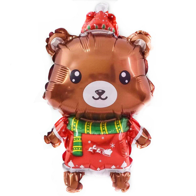 Festive bear-shaped foil balloon wearing a red Christmas outfit with white patterns, a red santa hat, and a green and yellow striped scarf.