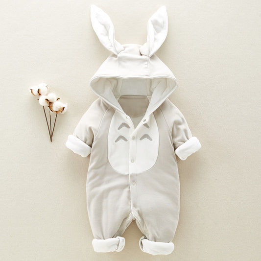 Baby onesie with bunny ear hood, featuring a cartoon face on the chest, buttoned front, and roll-up cuffs, laid on a neutral background with cotton plant accents.