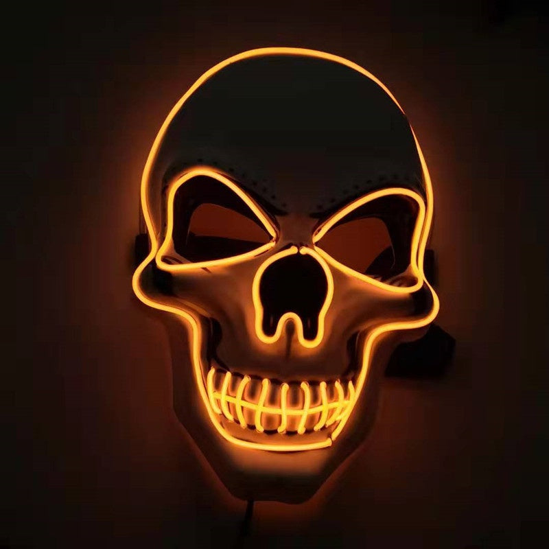 Glowing orange neon skull with hollow eyes and nose against a dark background, teeth outlined boldly.