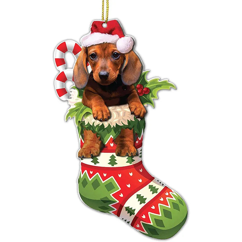 Dachshund puppy in a Christmas stocking ornament, wearing a Santa hat. The stocking is red and green with festive patterns, holly leaves, and a candy cane accent.
