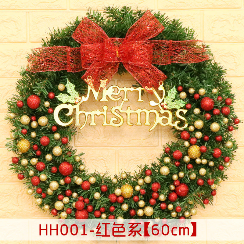 Christmas wreath with red and gold baubles, a red bow, and "Merry Christmas" text, set against a yellow brick wall. Wreath measures 60cm in diameter.