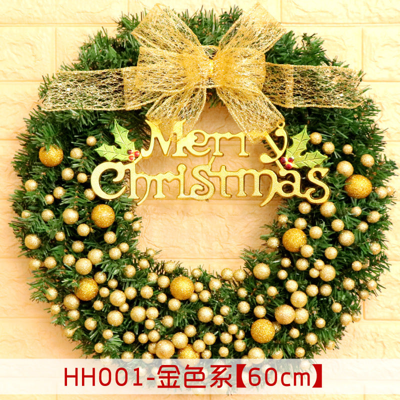 A festive Christmas wreath adorned with gold baubles and a large glittery gold bow, featuring a "Merry Christmas" sign and holly leaves. The wreath measures 60cm in diameter.
