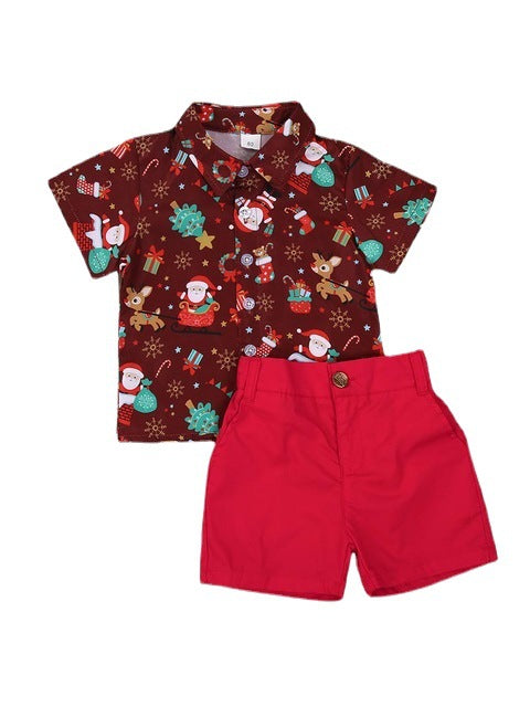 Toddler outfit with a festive, short-sleeve shirt featuring Santa, snowmen, and reindeer on a brown background paired with bright red shorts, perfect for holiday celebrations.
