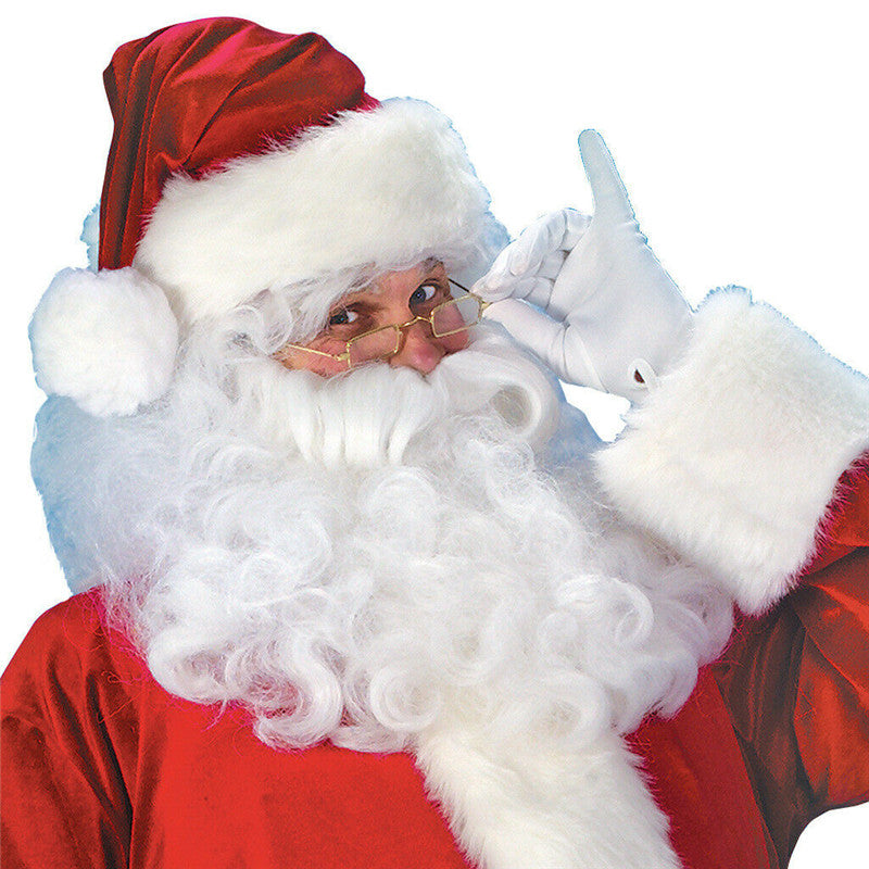 Santa Claus in a red suit and hat holds his glasses, smiling with a gloved hand raised to his cheek. His white beard is full and curly, against a plain background.