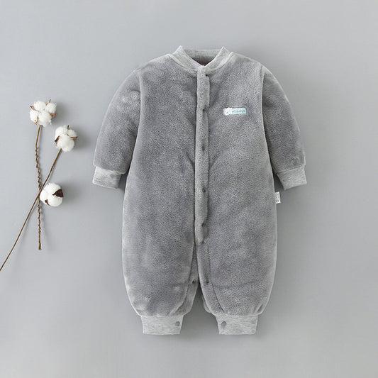 Gray fuzzy baby romper with snap buttons displayed on a neutral background. Soft texture with cotton plant accents on the left, conveying a cozy, comfortable feel.
