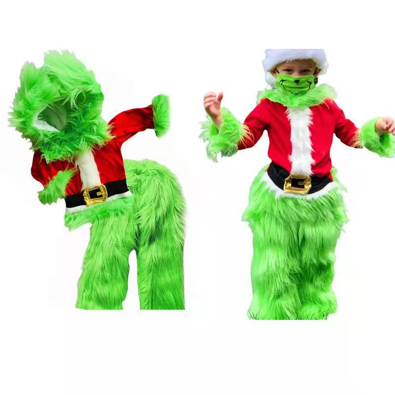 Child in a green furry costume with red Santa outfit, featuring white trim and a black belt. The costume includes a hood and gloves, mimicking a playful, festive character.