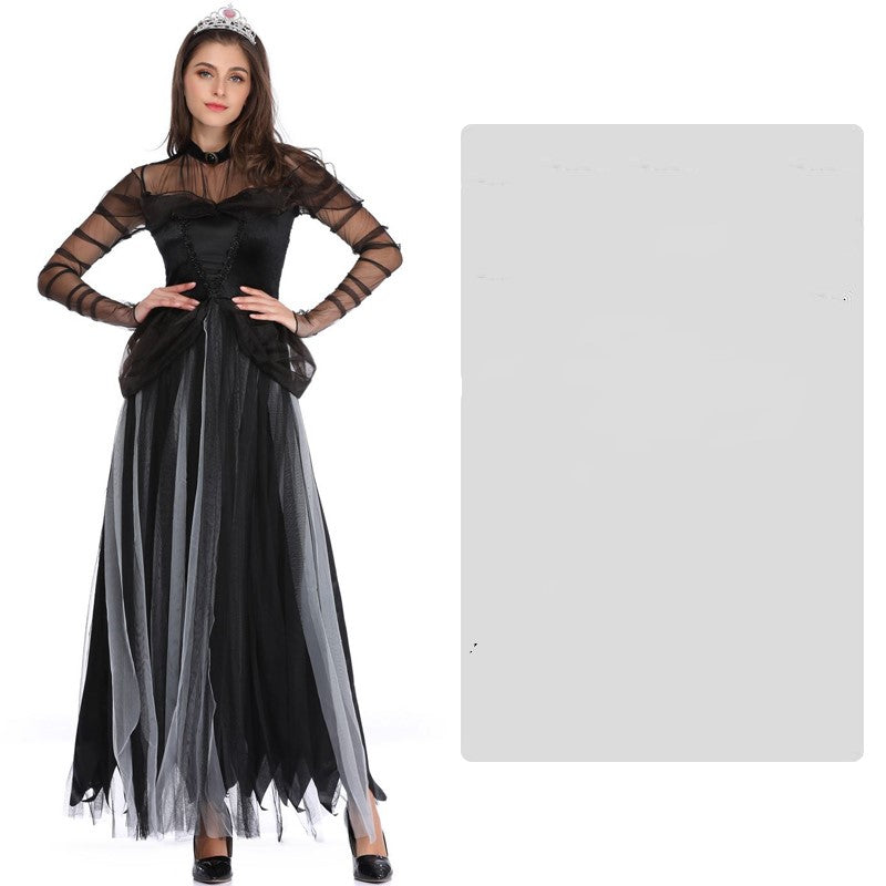 Woman in a black and gray gothic dress with sheer sleeves, wearing a tiara. Her hands rest on her hips against a plain background.