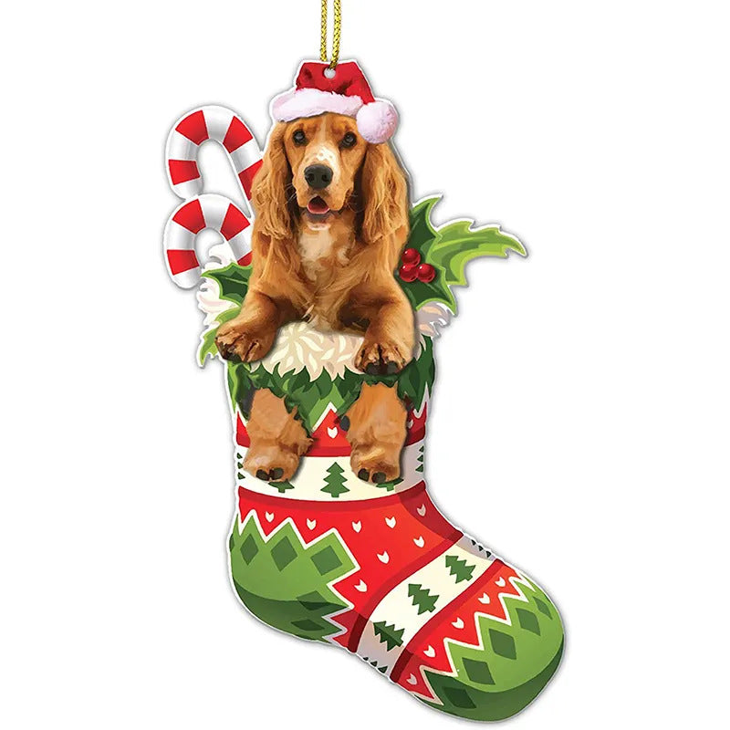 A festive ornament showing a dog wearing a Santa hat sitting in a colorful Christmas stocking with candy canes and holly, on a white background.