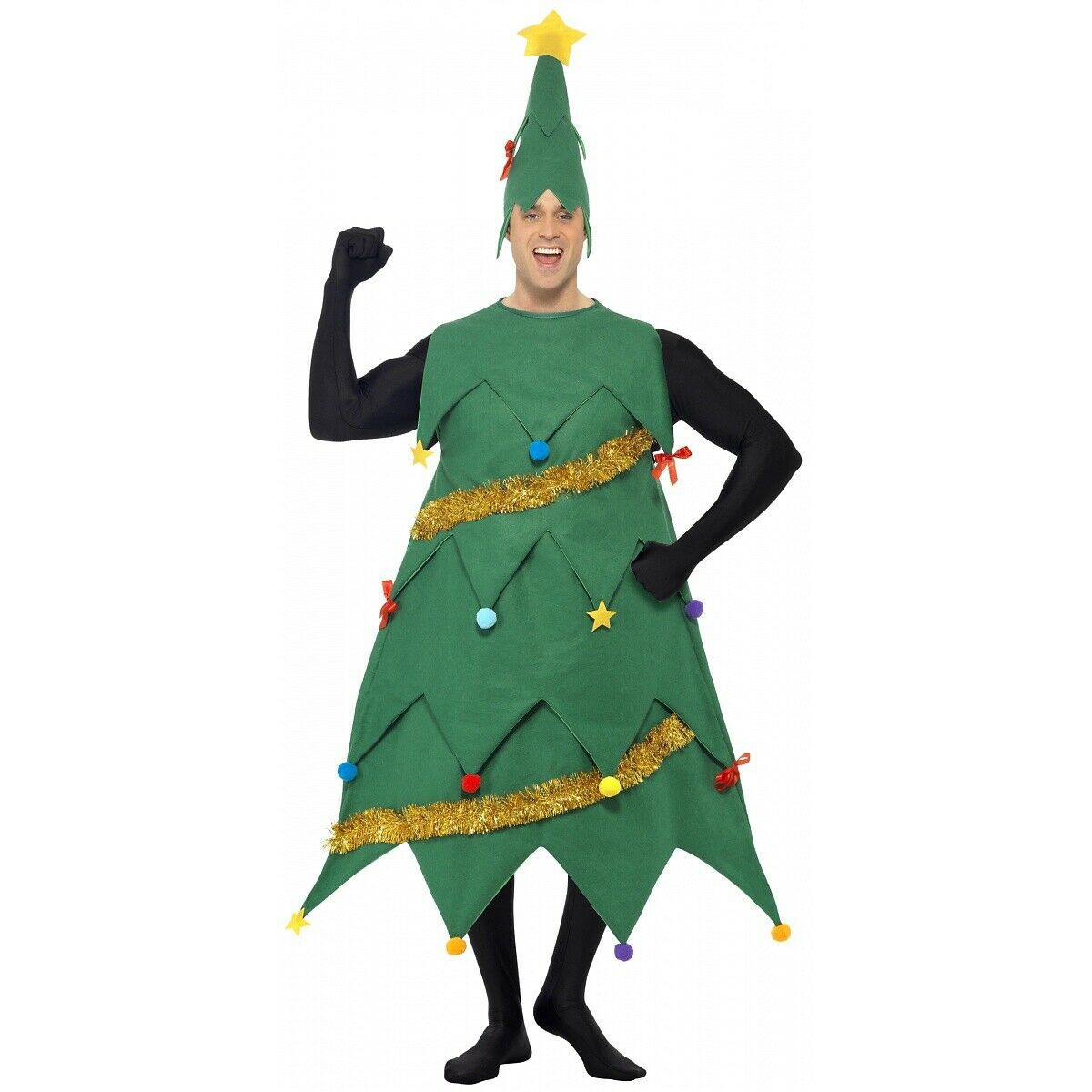 Person in a festive Christmas tree costume, adorned with colorful ornaments and a tinsel garland, raises one arm in a cheerful pose. The costume is topped with a star.