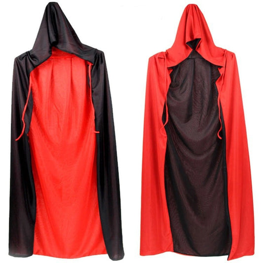 Two reversible hooded capes are displayed. The left cape is black with a red lining, while the right cape is red with a black lining. Both have drawstrings and are made of smooth fabric, showing the contrasting colors when reversed. They hang against a plain white background.