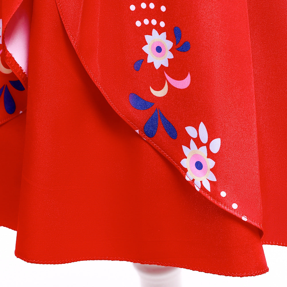 Close-up of red fabric with floral patterns. White and pink stylized flowers and blue leaves add contrast against the vibrant red background, creating a lively design.