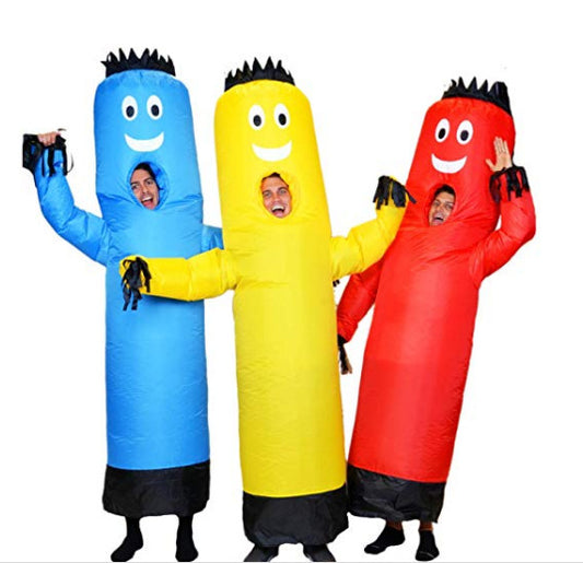 Three people in colorful inflatable tube costumes—blue, yellow, and red—pose cheerfully with arms raised. Each costume has a smiley face and black accents on top and bottom.