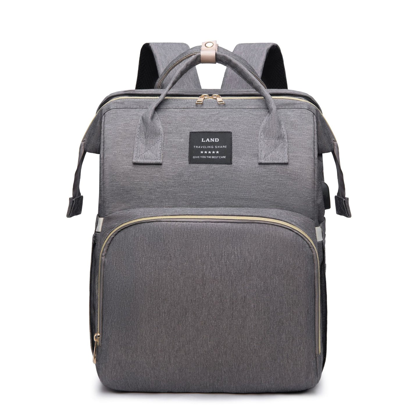 Gray backpack with a rectangular shape and multiple zippers. Features include top handles, adjustable shoulder straps, and a front pocket with a label that reads "Land Traveling Share."