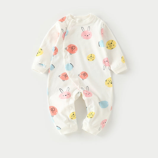 White baby onesie with colorful animal faces in pink, yellow, blue, and red, featuring smiling bears and rabbits. Made from soft fabric with snap buttons for easy dressing.