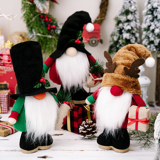 Three festive gnomes with long white beards and colorful hats. One holds a gift, another a plant. They're surrounded by holiday decor: pinecones, presents, and evergreen branches.