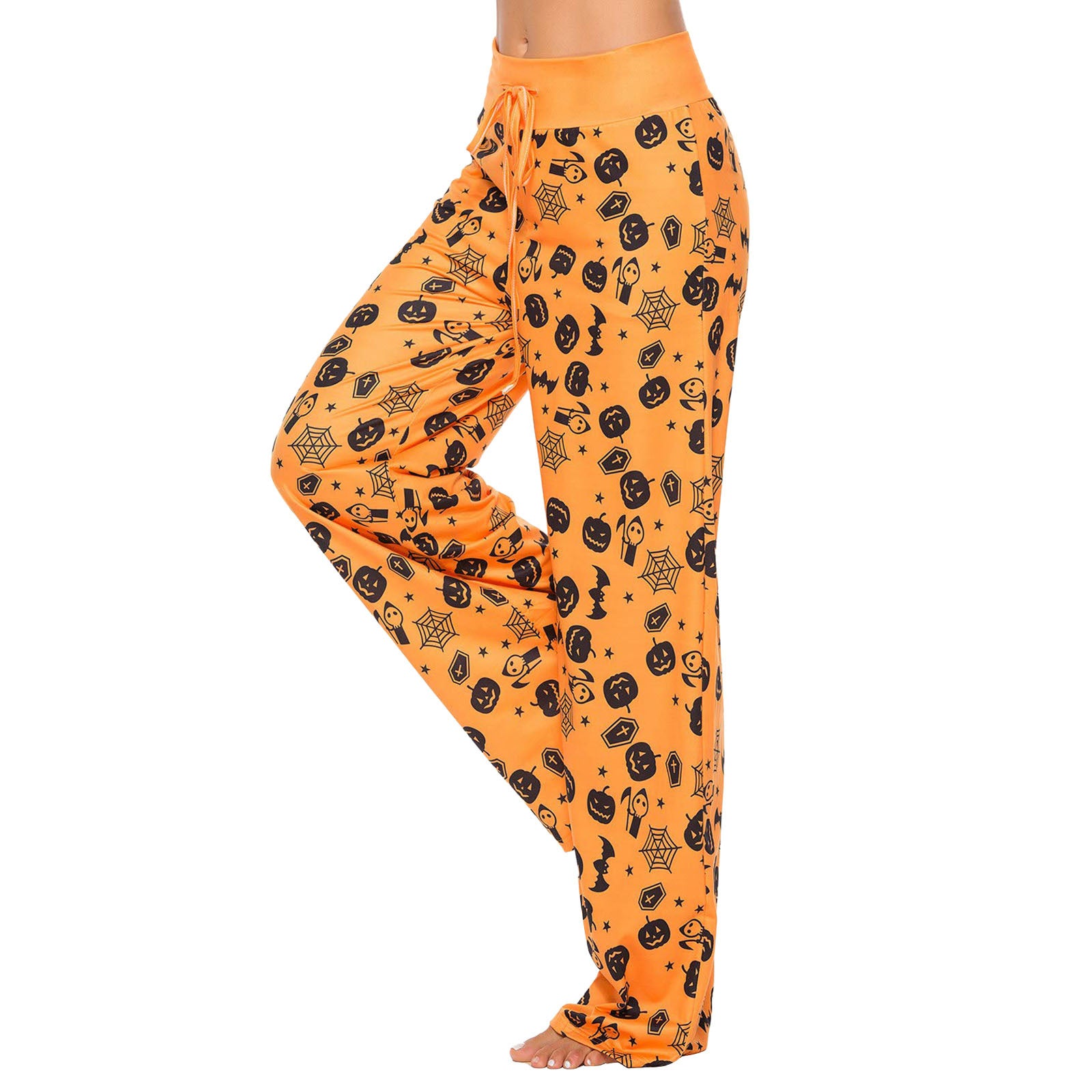 Orange pajama pants with a Halloween theme; features black pumpkin, spider, bat, and web patterns. The pants have a drawstring waist and are worn by a person standing barefoot.